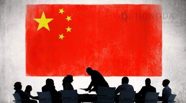 chinese flag with shadows of people around a table working or discussing