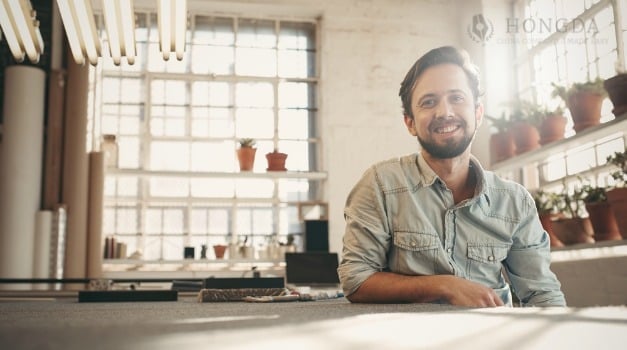 man smiling in an apartment with plants