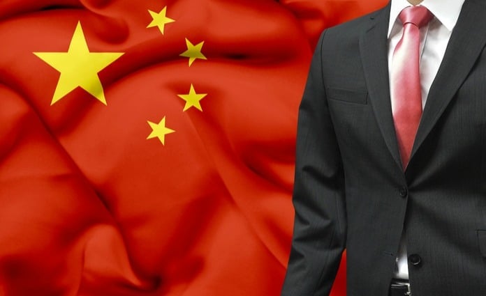 business man in front of chinese flag