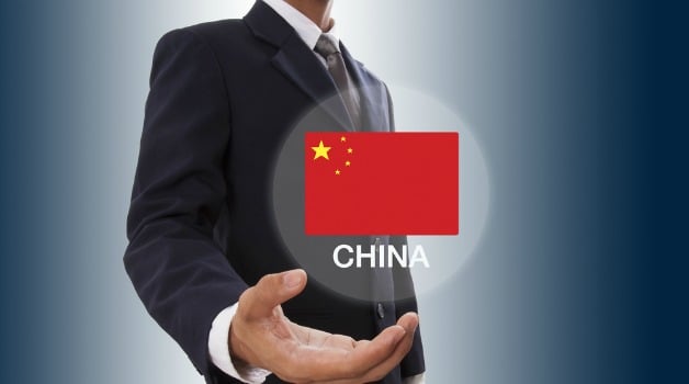 man with hand out with a picture of china flag