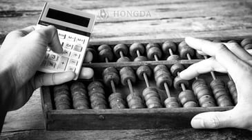 someone using calculator and abacus 