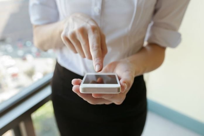 person pointing at phone