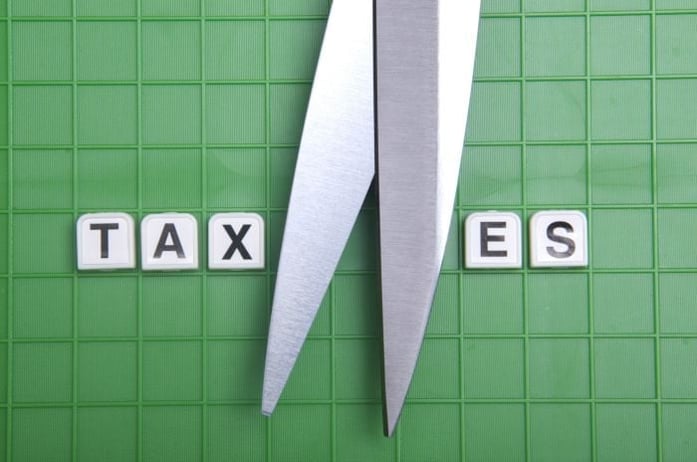 scissors in the middle of the word taxes